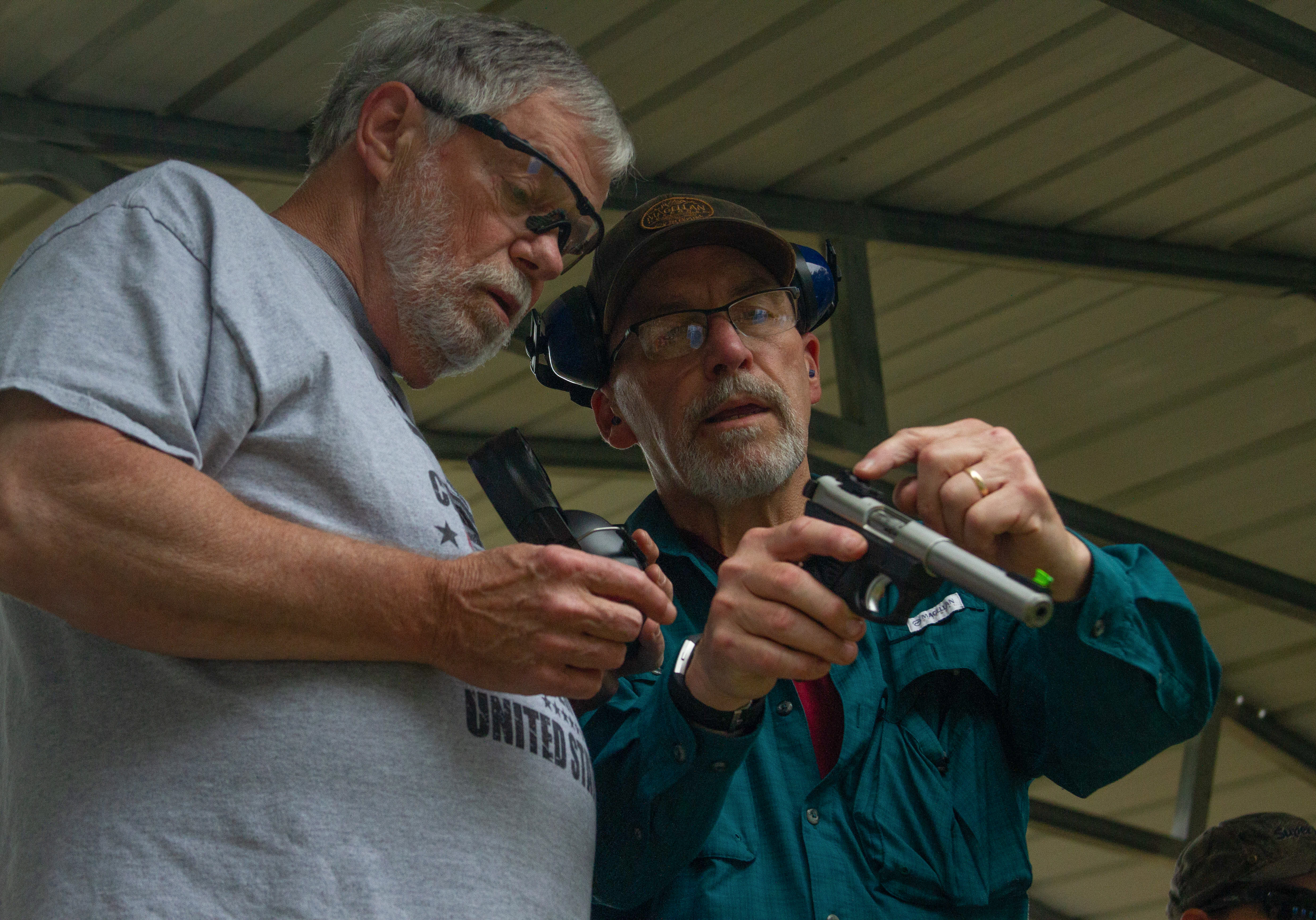 Richard Miller shows Alamance resident Tom Shanklin how to properly place his hands on a handgun during a concealed carry class on Sept. 14, 2019. Photo by Anton L. Delgado | Elon News Network