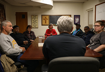 Every Wednesday evening from 5:30 p.m. to 7 p.m., Phil Bowers, founder and executive director of Sustainable Alamance, leads a Bible study session with volunteers and former criminals in the basement of Beverly Hills United Church of Christ in Burlington. Photo by Anton L. Delgado.
