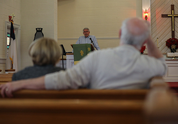 Shaun and Carol Hyndshaw, who have attended church services in Beverly Hills United Church of Christ for the last 40 years, listen to Phil Bowers, founder and executive director of Sustainable Alamance, preach on Sunday, Dec. 8. Photo by Anton L. Delgado.